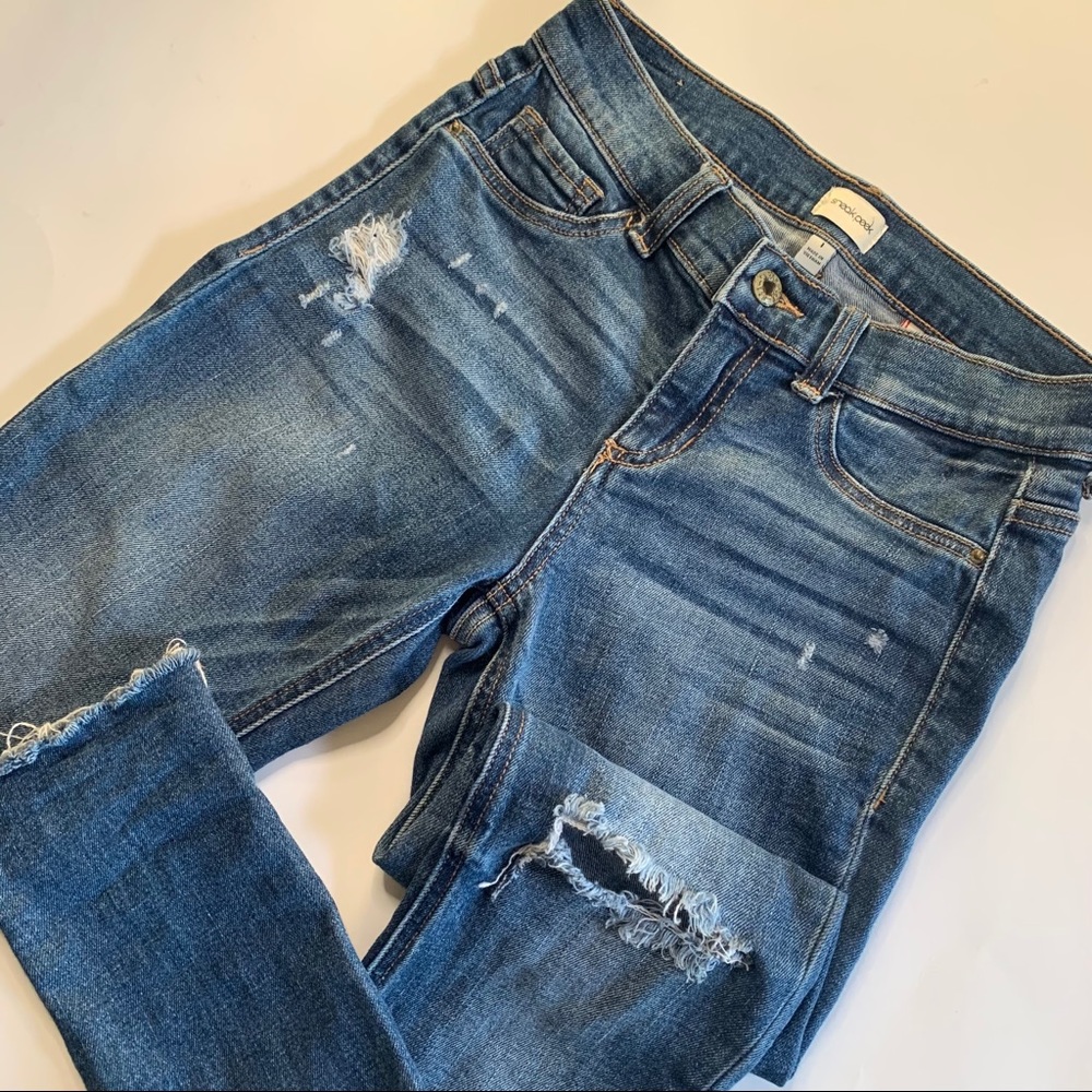 Medium wash mid rise skinny with distressing